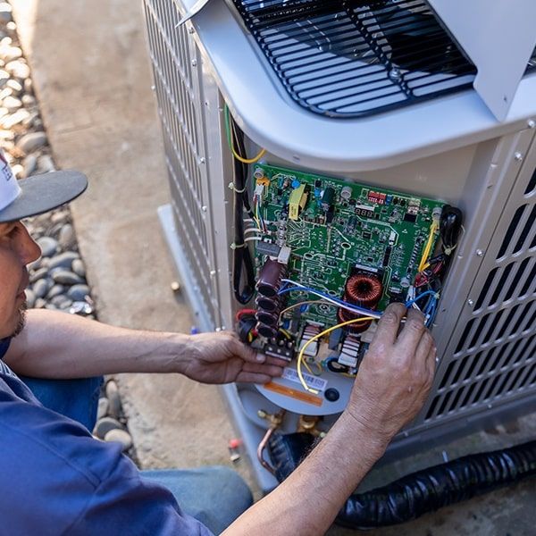 Air conditioning technician working on an outdoor unit